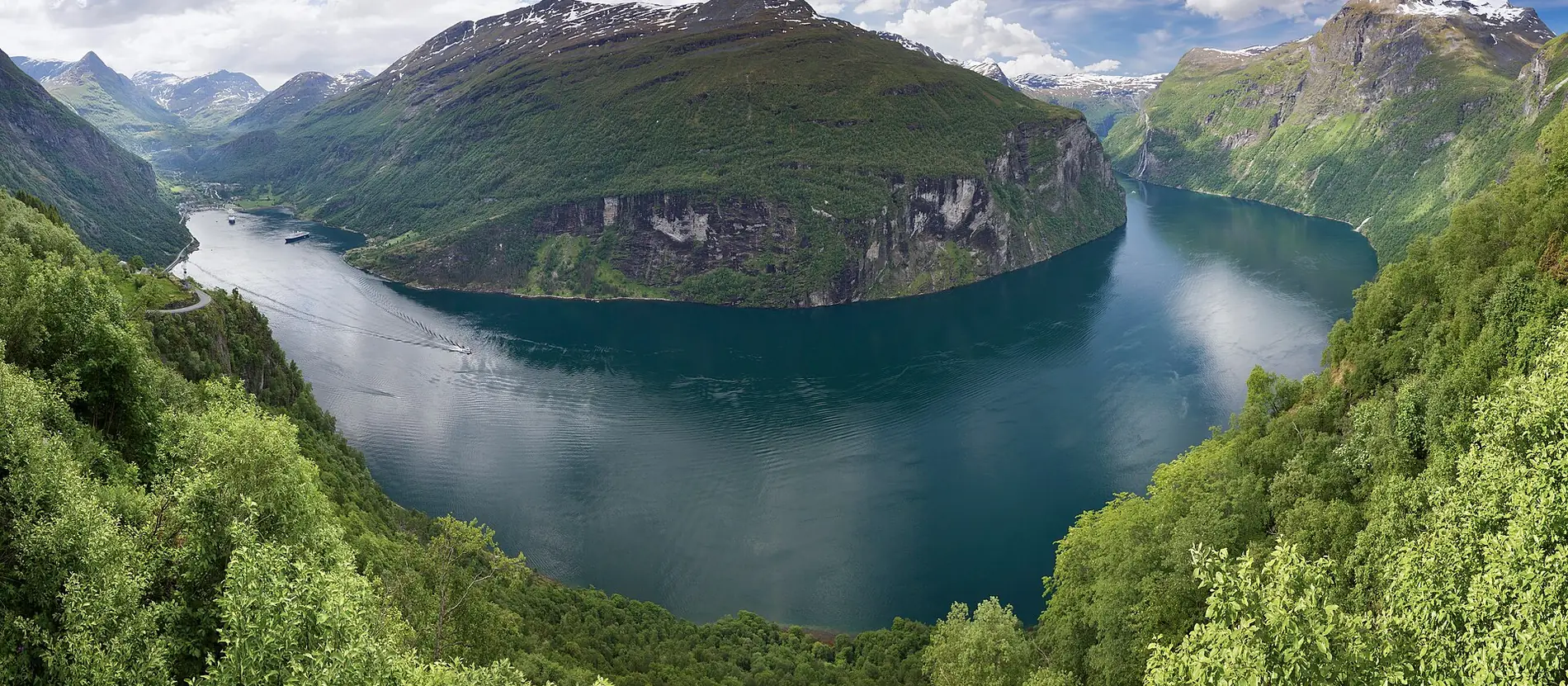 A Norwegian fjord seen from above, ferry water winding between steep mountains